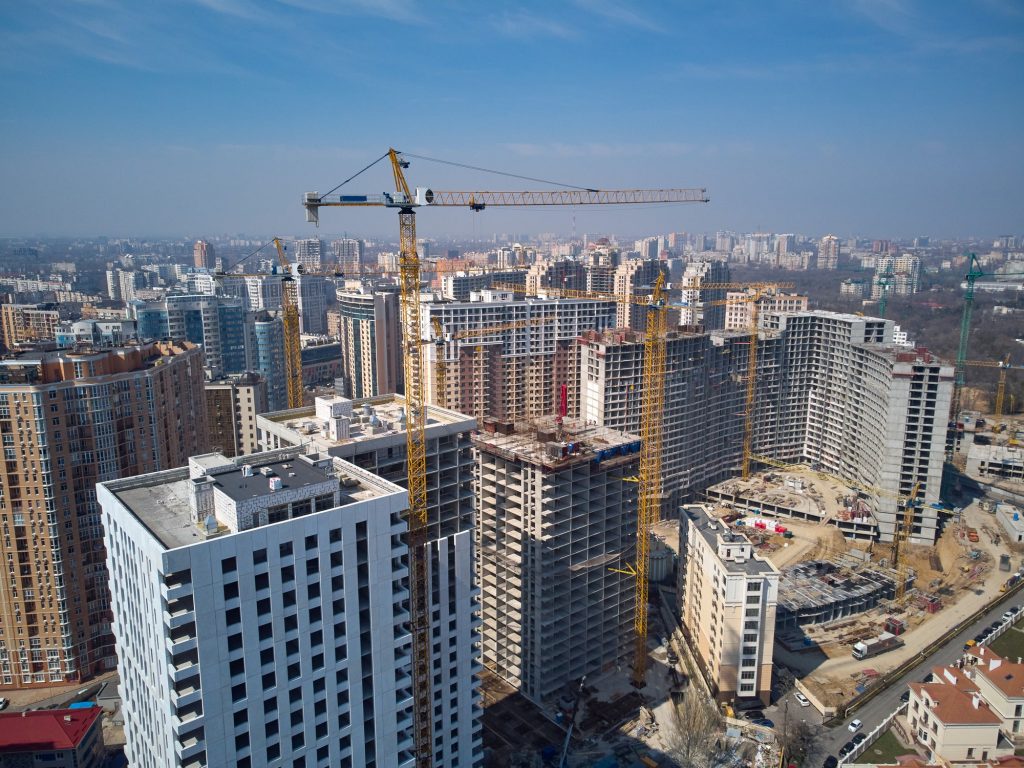 Busy Construction Site and Construction Equipment Aerial Photo at sunset