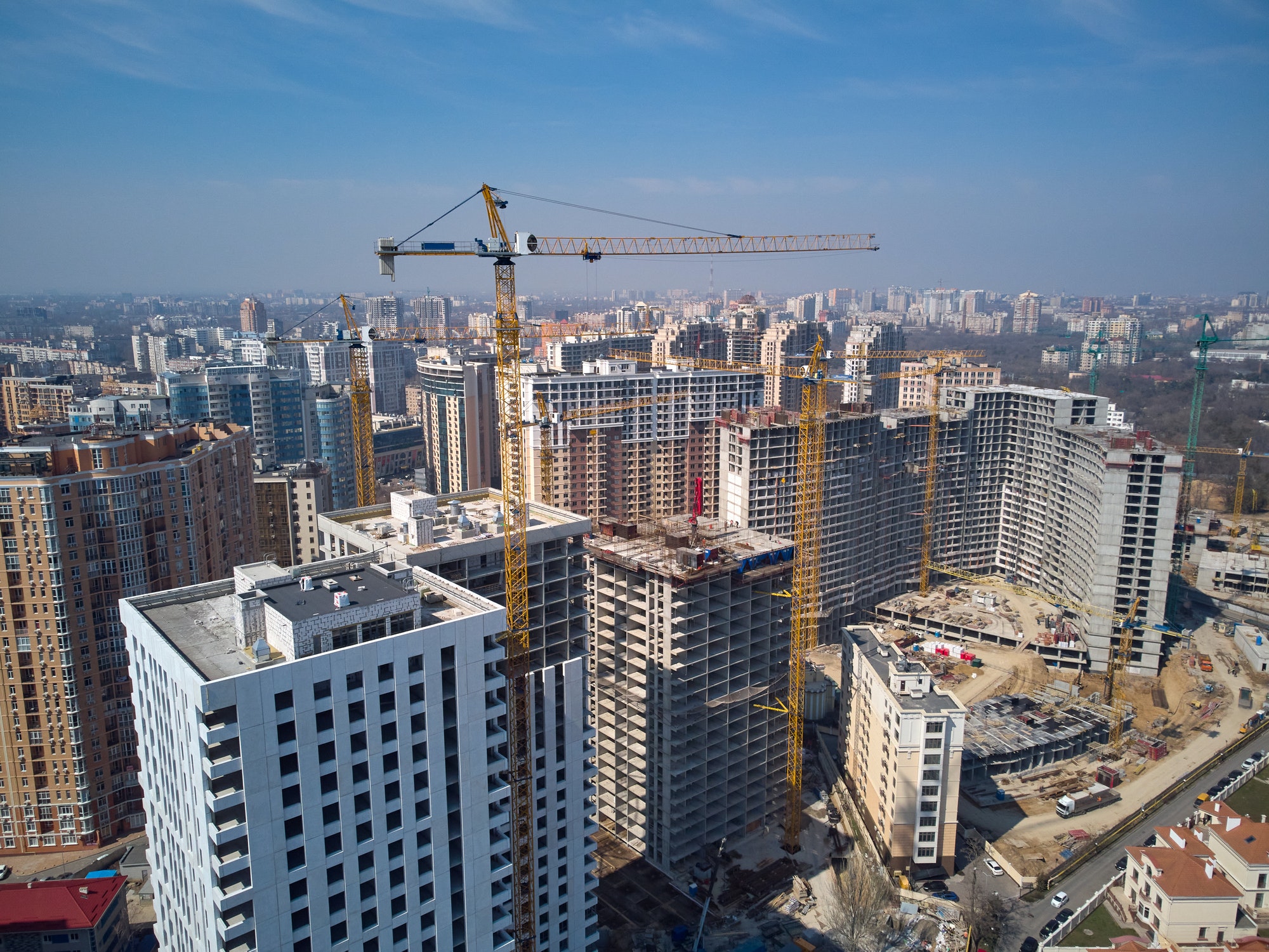 Busy Construction Site and Construction Equipment Aerial Photo at sunset